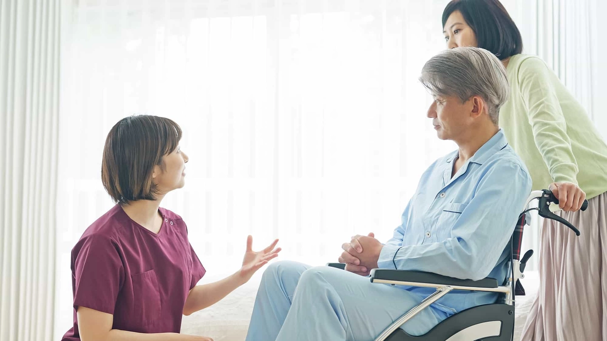 看護師の説明を聞く患者と家族