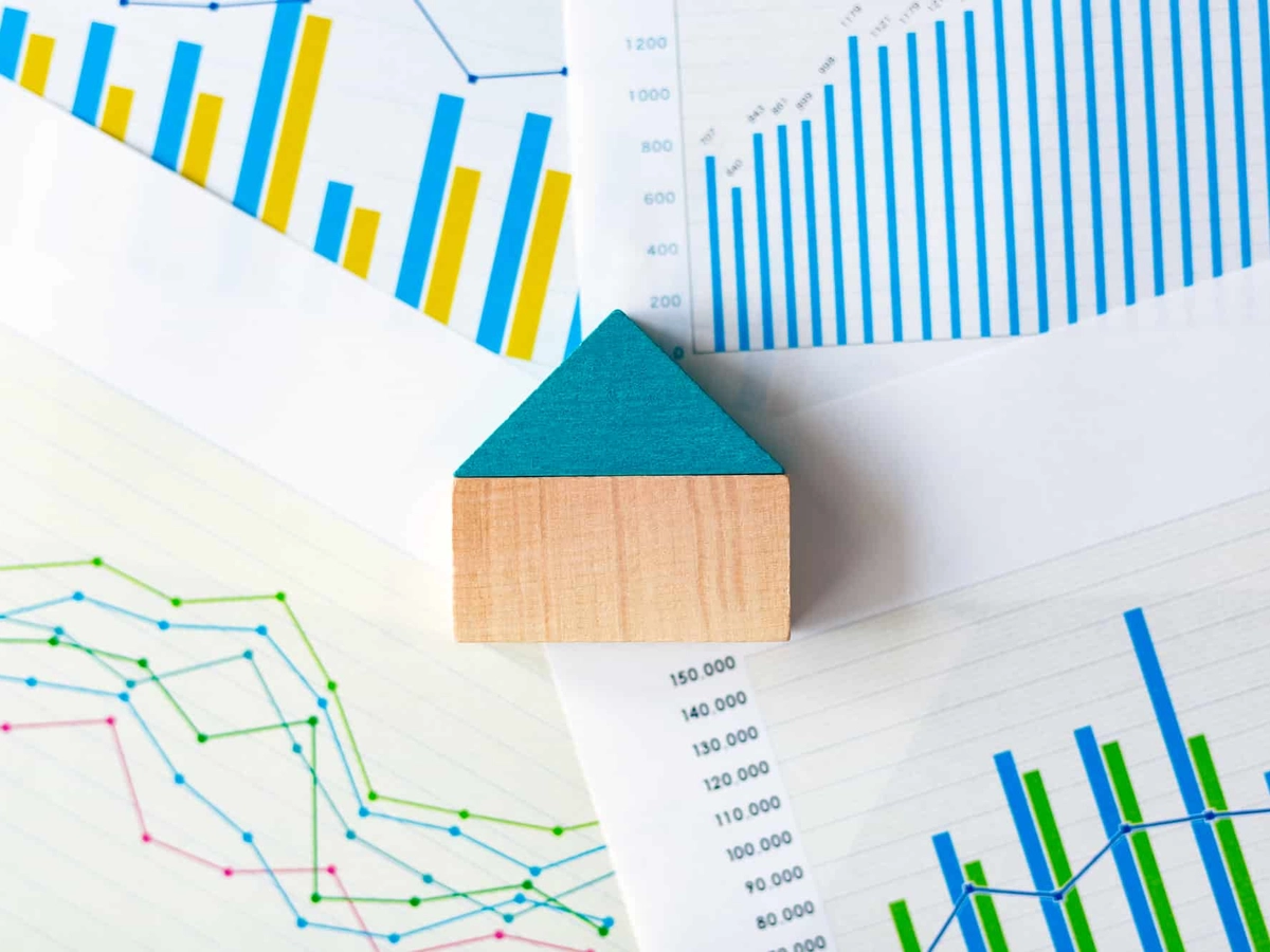 ミニチュアの家とたくさんのグラフ