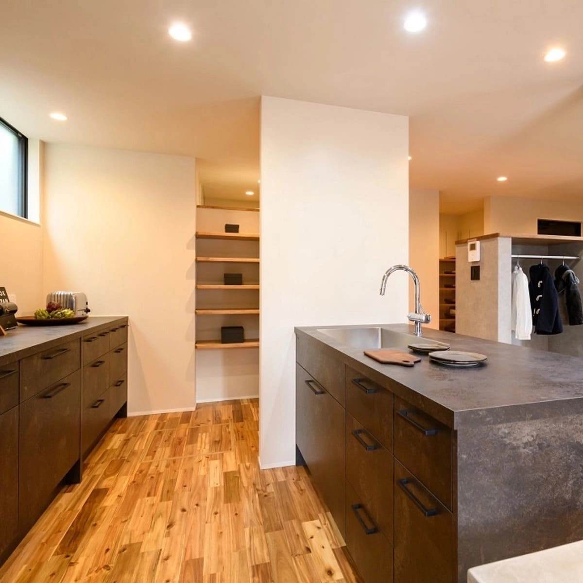 グレーのキッチンと奥に設置されたパントリー