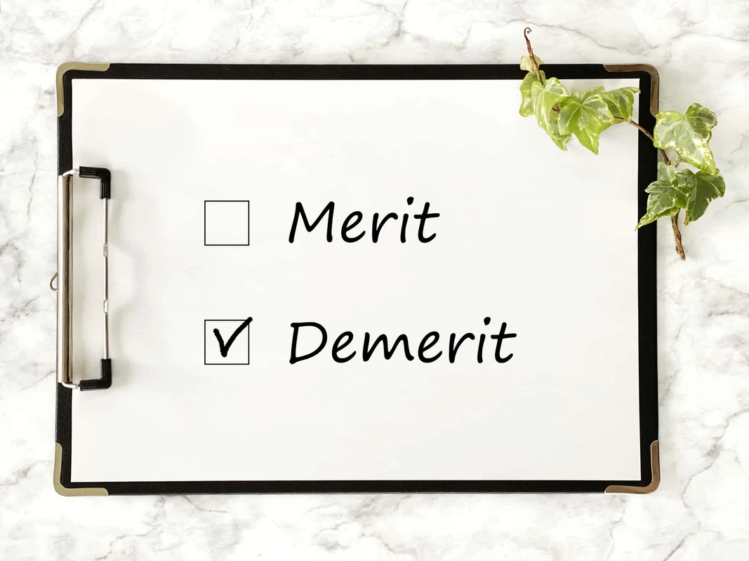 デメリットにチェックが入ったクリップボードの紙