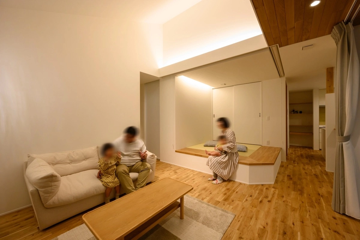 小上がりの畳コーナーで家族がくつろぐ開放的なリビング