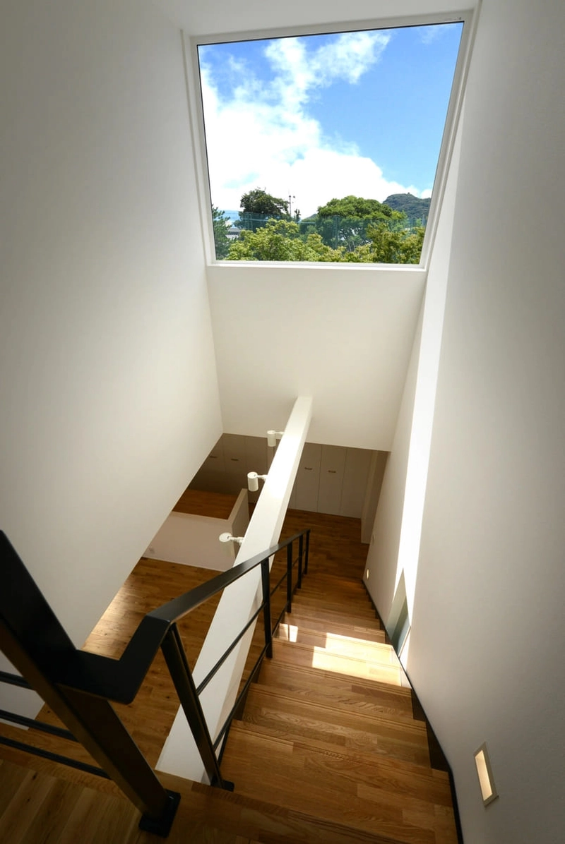 天窓から青空が見える木製段板の階段